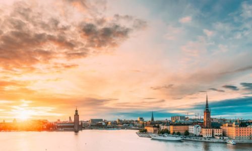 Stockholm, Sweden. Scenic Famous View Of Embankment In Old Town Of Stockholm At Summer. Gamla Stan In Summer Evening. Famous Popular Destination Scenic Place And UNESCO World Heritage Site.